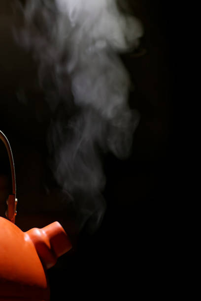 istock Orange kettle with boiling water and steam from the spout 960623812