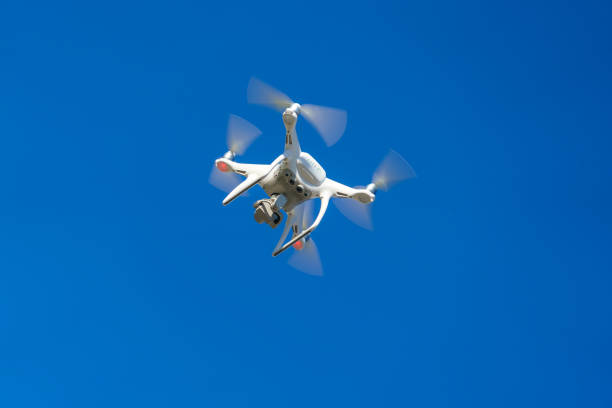 istock White air drone quadrocopter against the blue sky 960624028