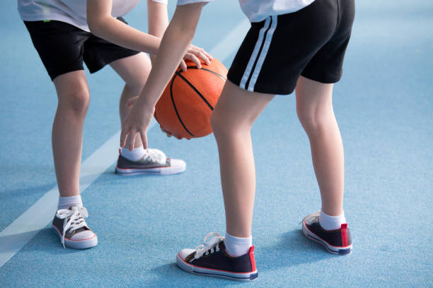 istock Children learning to dribble basketball 960628062