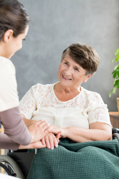 istock Nurse comforting senior 960631104