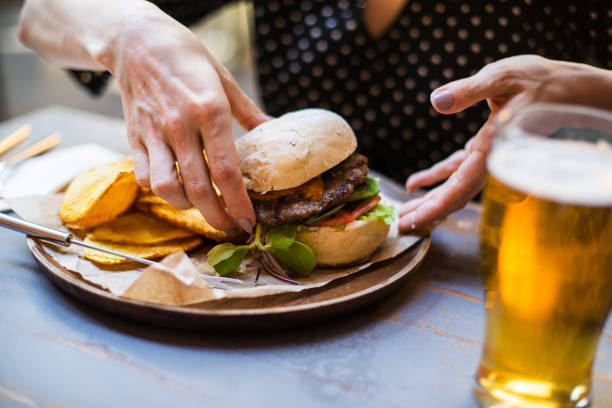 istock Woman holding hamburger 960631680