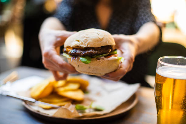 Woman holding hamburger