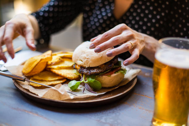 istock Woman holding hamburger 960631734