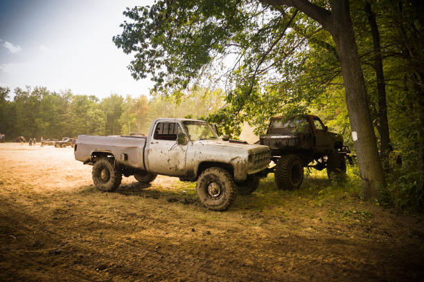 Tweed, Canada - September 10, 2006:  Four by four trucks parked under a tree at a mud run festival.