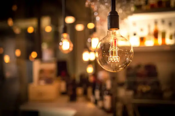 Photo of Vintage lamp bulb with bar or cafe night abstract background