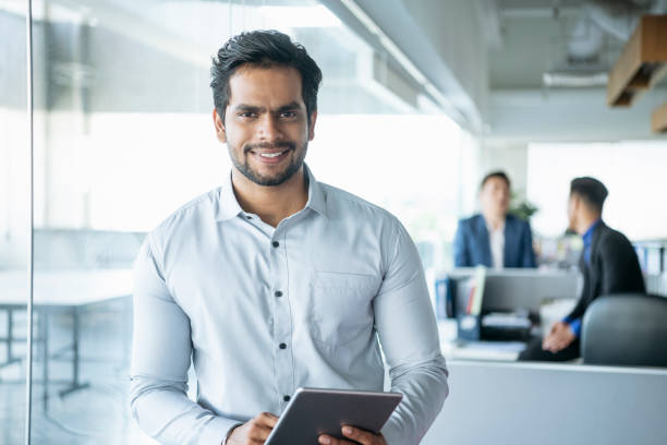 istock Businessman with digital tablet smiling 960644998