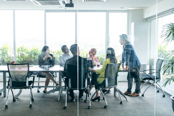 istock View through glass towards business meeting 960645110