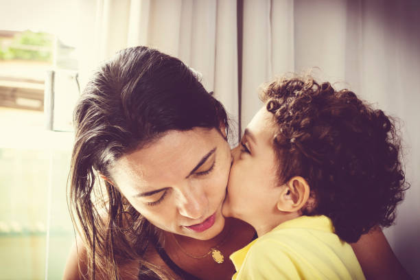 istock Mother and son kissing with love. 960647782