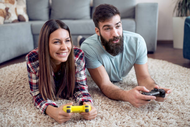 istock Young couple playing video games 960659328