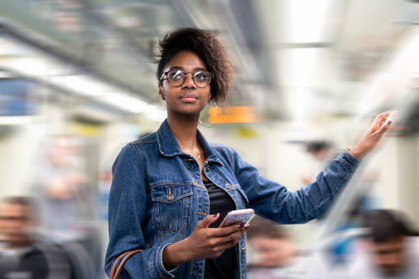 istock Young black woman using mobile in the subway 960661970
