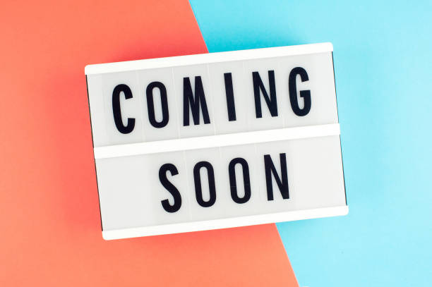istock Coming soon - text on a display lightbox on blue and red bright background. 960667318