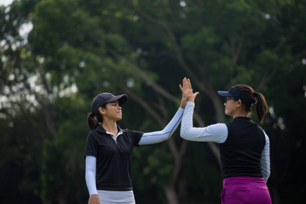 istock Golfers celebrating the game with a high five 960669720