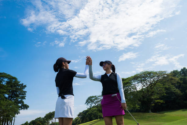 Golfers celebrating the game with a high five