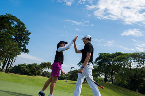 istock Golfers celebrating the game with a high five 960669828