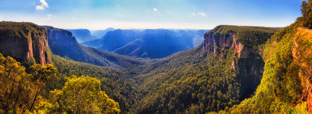 BM Govett leap sunlight canyon Bridal vale waterfall from Govett leap lookout towards Pulpit rock and surrounding sandstone mountain ranges in Blue Mountains on a sunny morning. blue mountains australia photos stock pictures, royalty-free photos & images