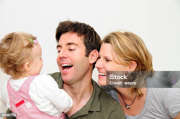 Happy Young Family Of Three Smiling Father Mother Toddler Stock Photo - Download Image Now