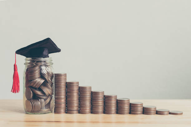 istock Scholarship money concept. Coins in jar with money stack step growing growth saving money investment 960676500