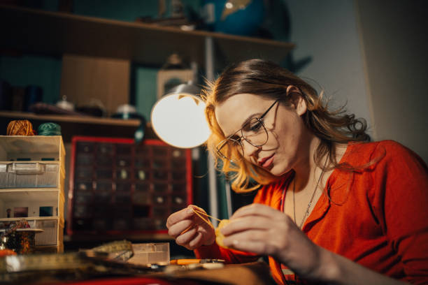 istock Young woman making jewelry indoors in the workshop 960682804