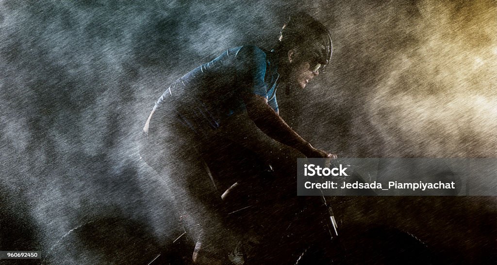 Cyclist cycling on mountain bike Man cycling/training on bike with foggy conditions Cycling Stock Photo