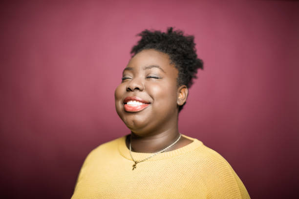 Smiling young woman with eyes closed