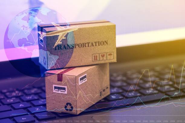 istock business concept:Two cardboard boxes with world map on notebook keyboard. Idea of International freight goods or shipping service for online shopping or e-commerce concept. freight forwarding product. 960696026