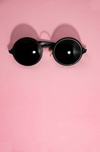istock Top view flat lay vintage sunglasses on pastel pink background 960699394
