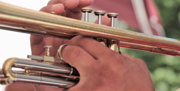 istock hands on a brass instrument,musicians playing outdoor,close up 960699632