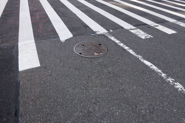 istock tarmac with man hole cover and white lines 960702594