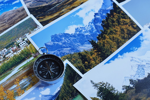 Compass on blur colorful photograph of popular toustist destination background, China traveling concept