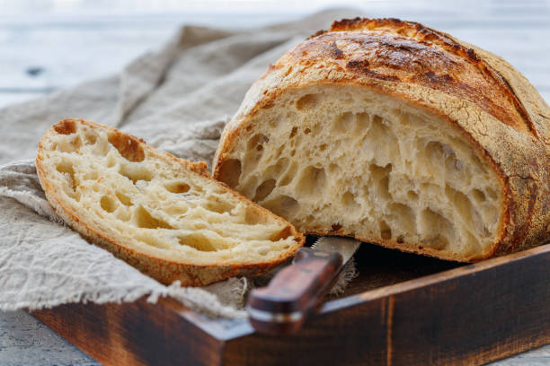 istock Cut loaf of artisanal wheat bread on sourdough. 960711232