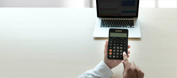 istock Close up businessman using calculator on documents Unrecognizable finance  use calculate about cost at office 960716300