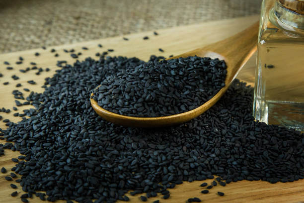 istock black Sesame seeds  on a old wooden table. 960720124