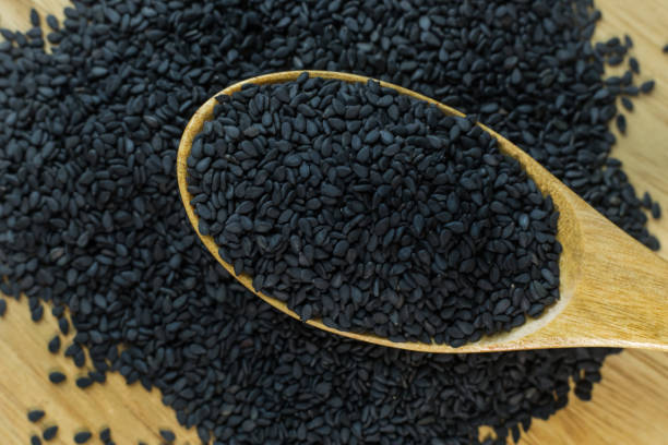 istock black Sesame seeds  on a old wooden table. 960720270