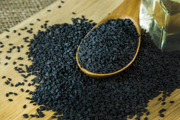 istock black Sesame seeds  on a old wooden table. 960720492