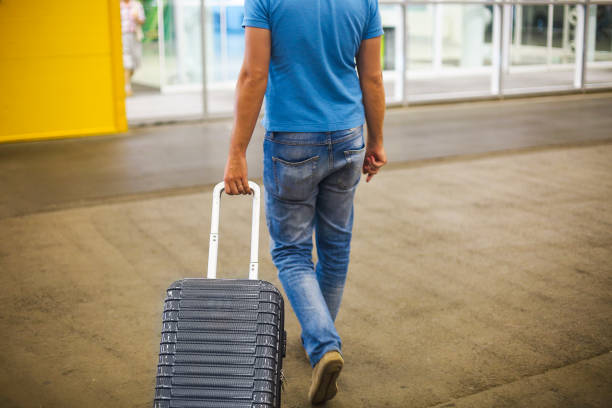 istock Young man with suitcase at airport or station 960726644
