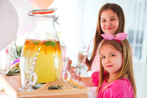 istock Kids by the candy bar with cake and citrus lemonade 960727278