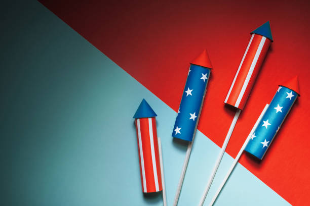 istock July 4, rockets for fireworks on a blue red background with space for text. in the style of minimalism 960739988