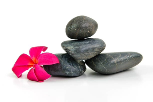 istock Stones pyramid with a plumeria flower 960744634