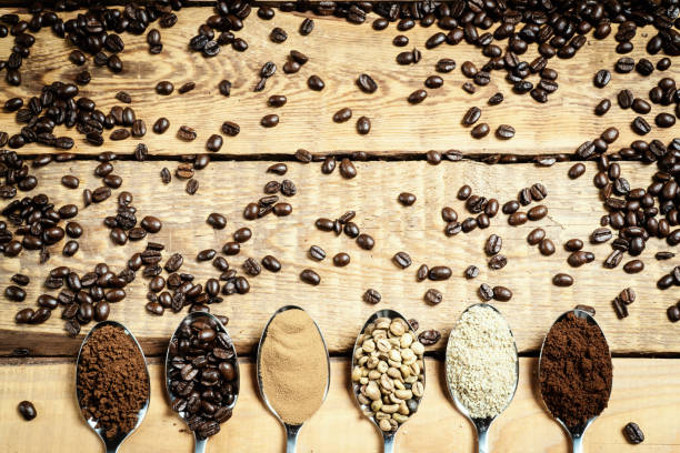 istock spoons with different types of coffee on a wooden table with seeds 960748198