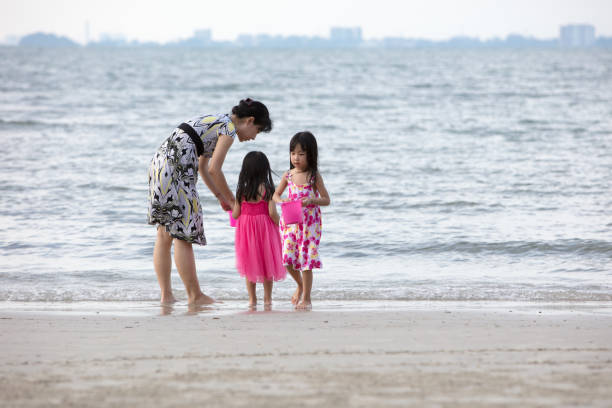 istock Asian Chinese mum and daughters playing sand together 960748474