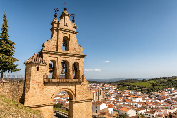 View of historic bell tower and picturesque Aracena village in Huelva, Andalusia, Spain. stock photo