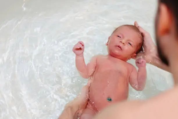 Photo of Newborn baby swimming in bath