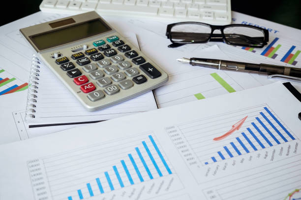 istock calculate on Data management. Document management. Business concept. Pile of documents on gray background. Graph, glasses and pen. 960752756