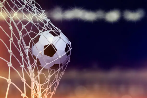 Soccer ball hit the net,success goal concept on stadium