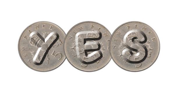 istock YES written with old British coins on white background 960757678