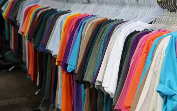 istock Multi Colored T Shirt Hanging In Store For Sale 960758802