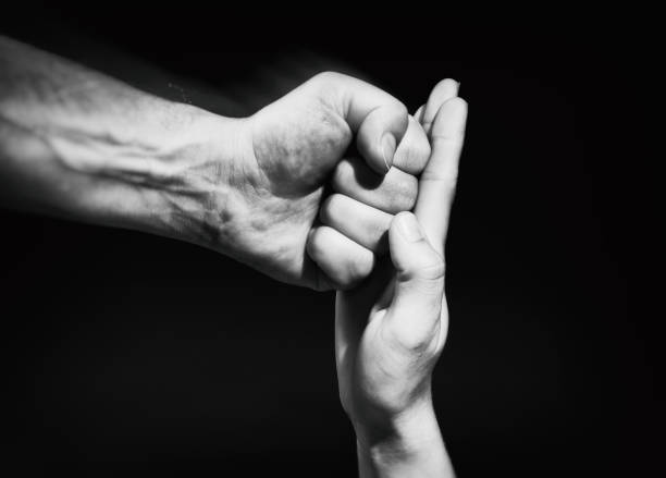 istock The female palm stops a male punch. 960759104
