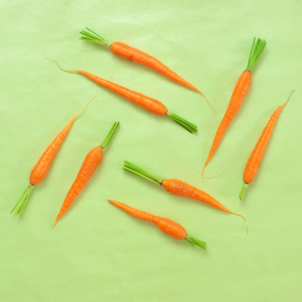 istock Fresh carrots on light green background 960766278