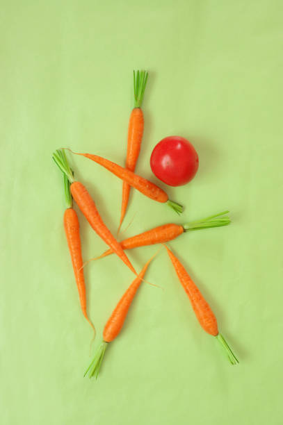 istock Fresh carrots and tomato on light green background 960766292