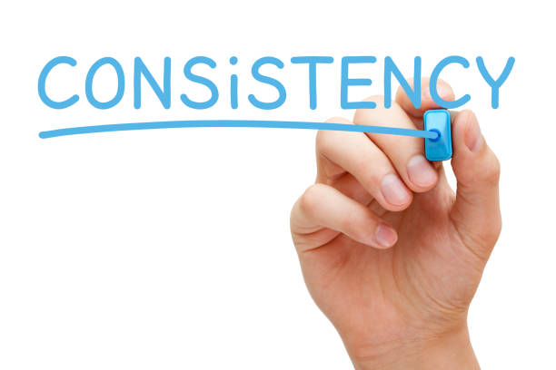 Consistency Handwritten With Blue Marker Hand writing Consistency with blue marker on transparent wipe board isolated on white. repetition stock pictures, royalty-free photos & images